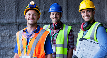 construction workers discussing project plans at a busy worksite